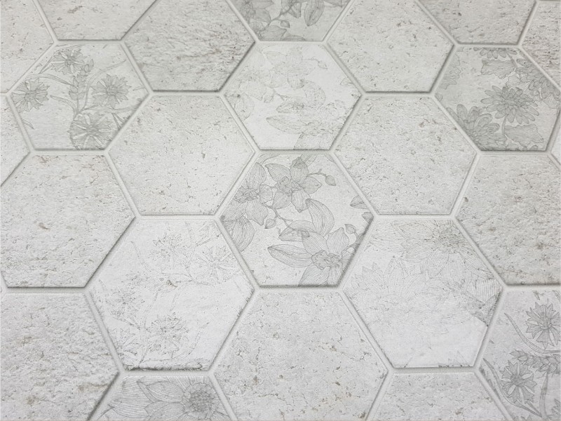 Hexagon natural stone tile design with soft floral detailing, commonly used in McKinney homes for bathroom floors and decorative accents.